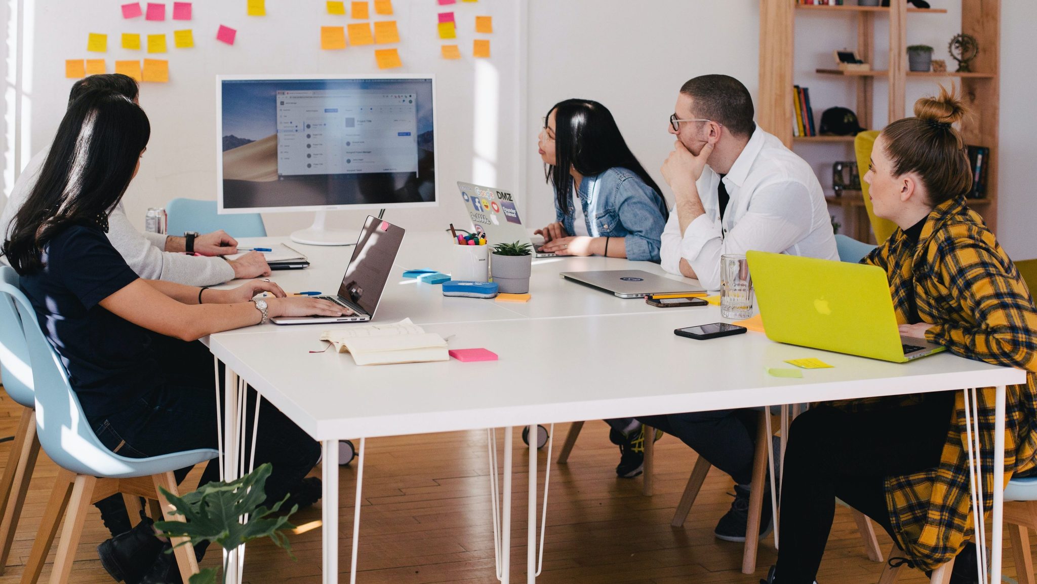 five person by table watching turned on white iMac